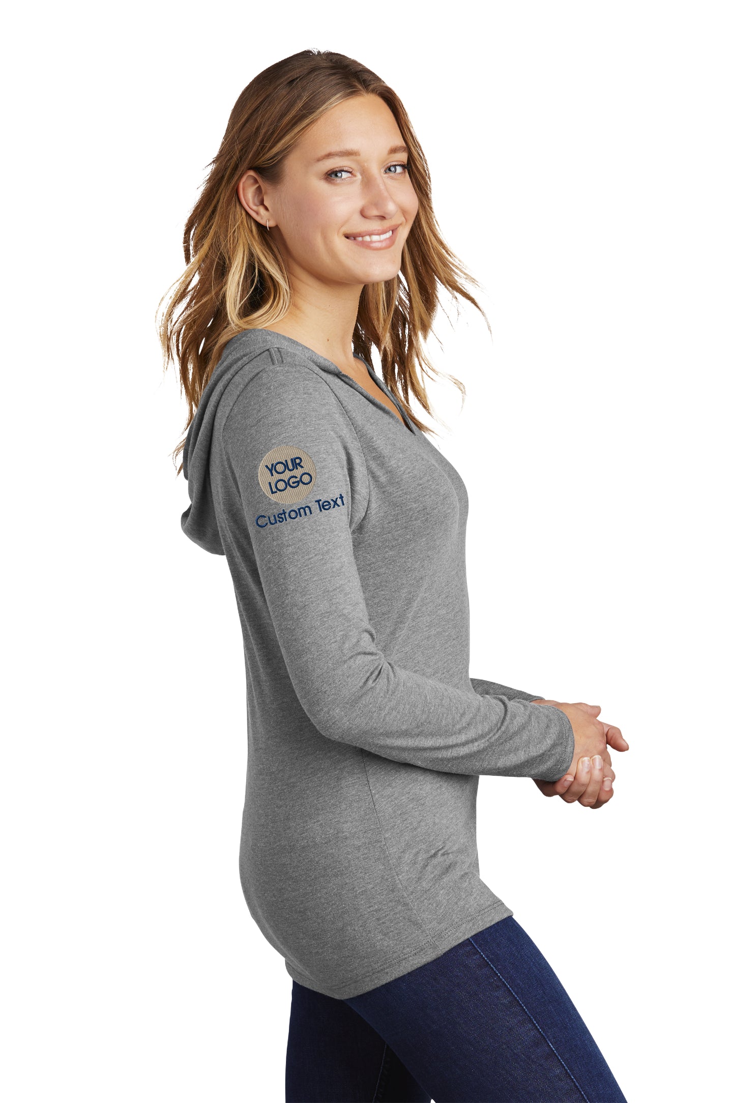 a woman wearing a gray shirt and jeans