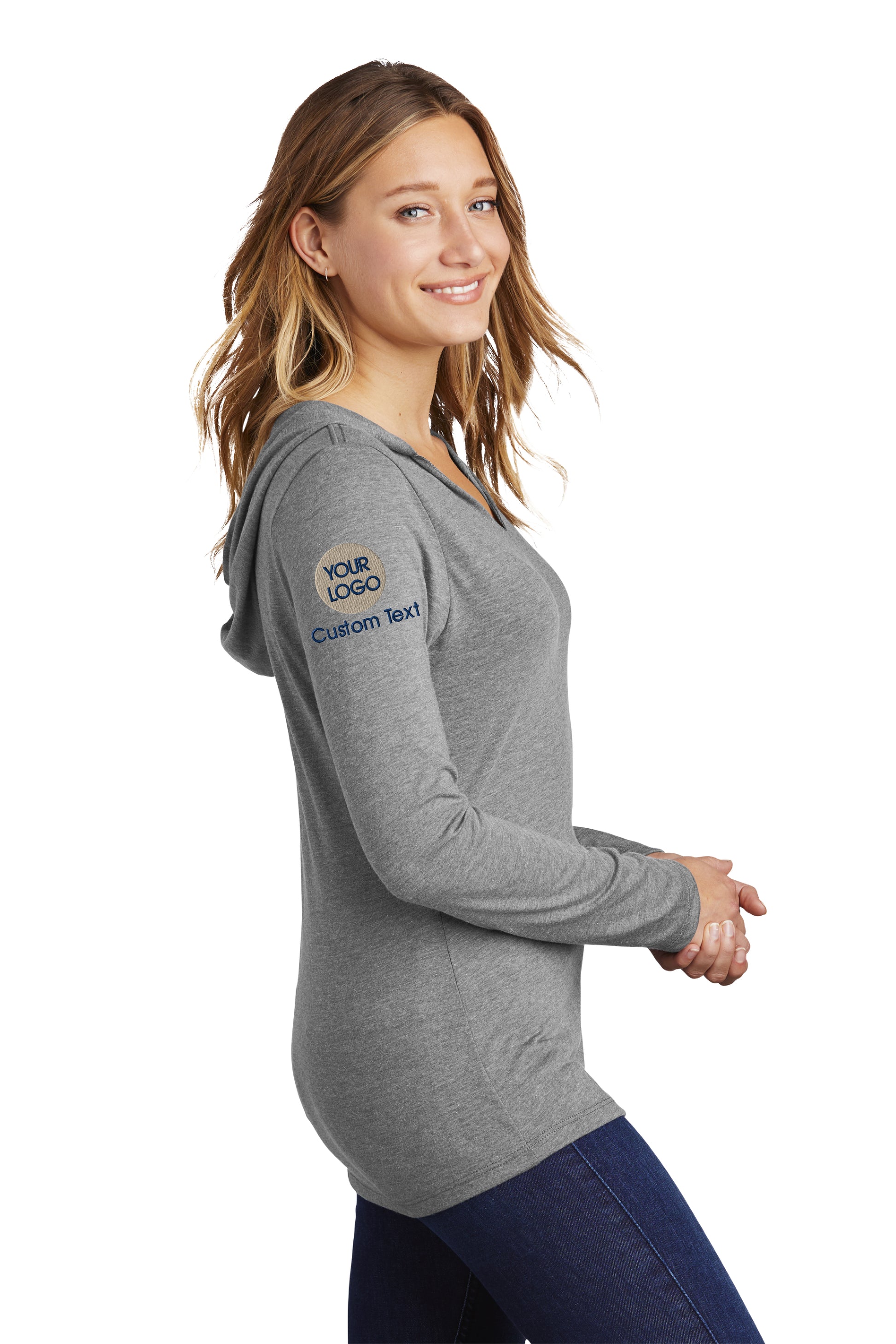 a woman wearing a gray shirt and jeans