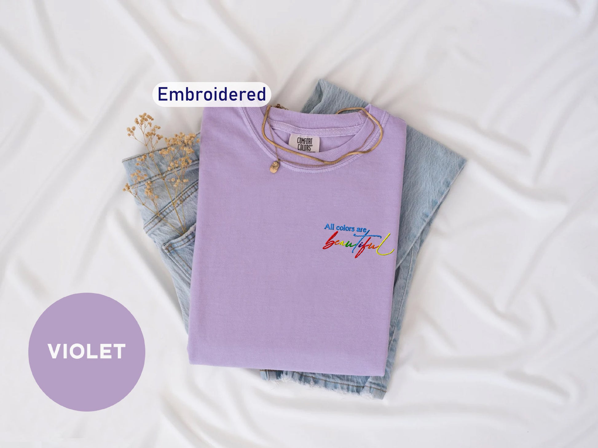 a t - shirt and jeans are laying on a bed