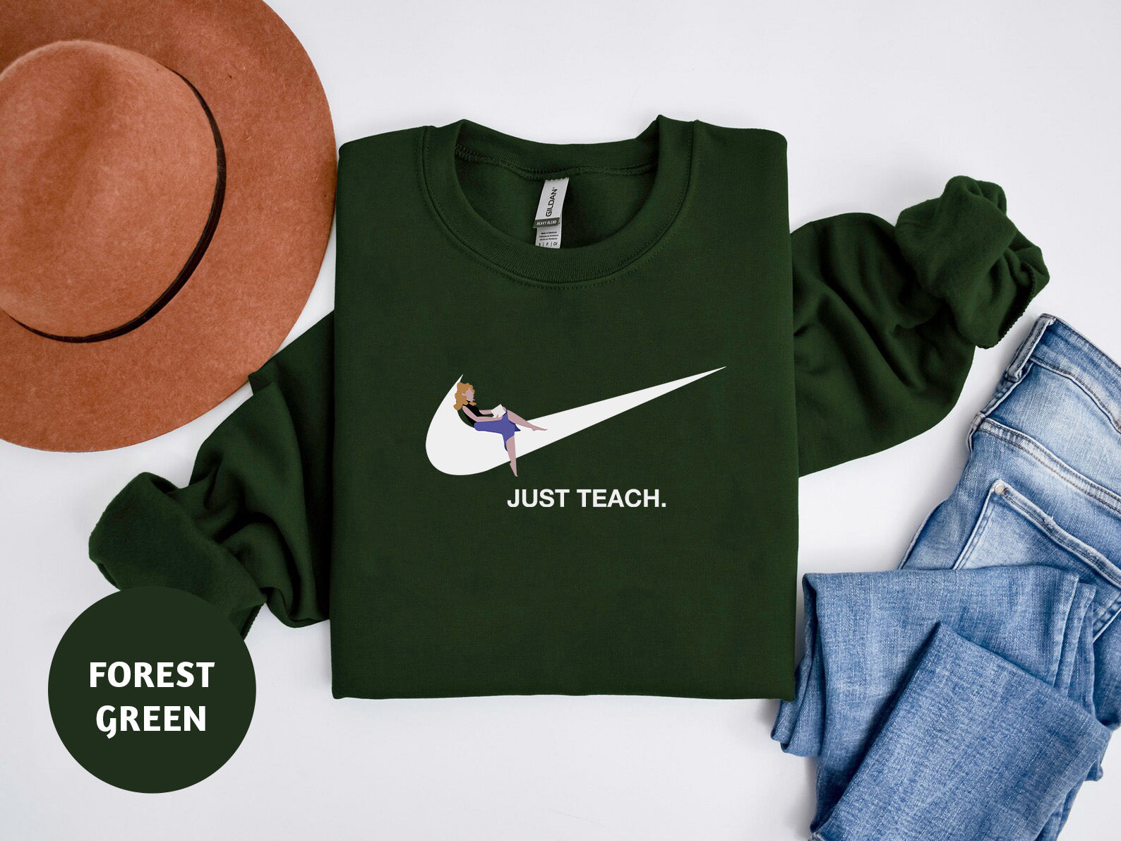 a t - shirt that says just teach and a hat next to it