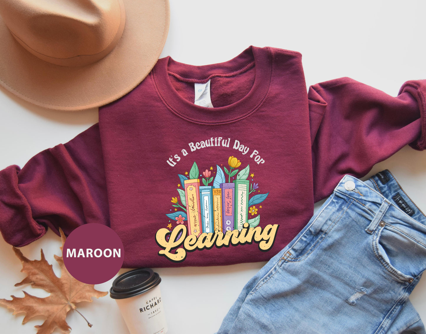 a maroon shirt that says, it's a beautiful day to be celebrating