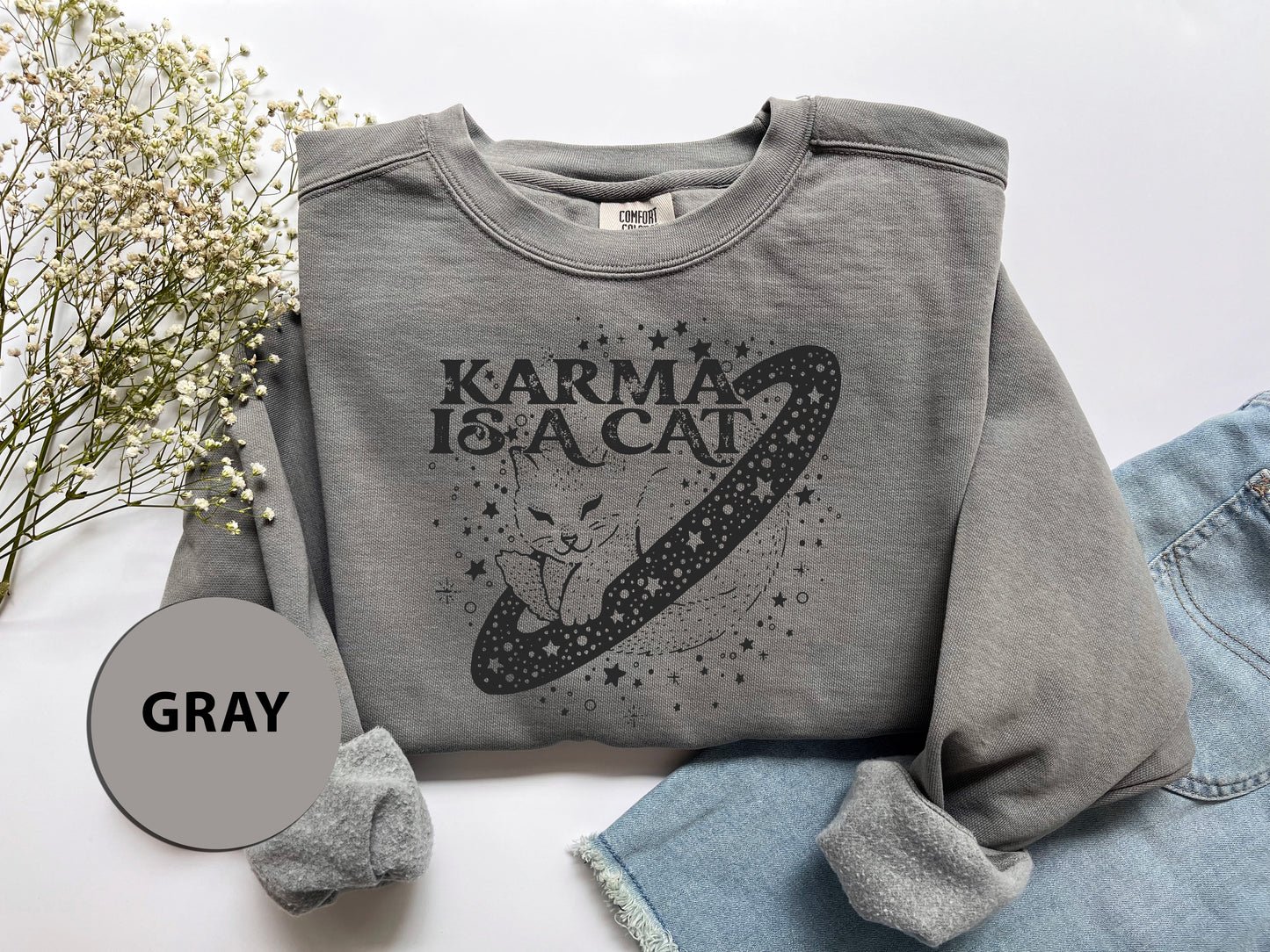 a gray sweatshirt with the words karma is a cat on it