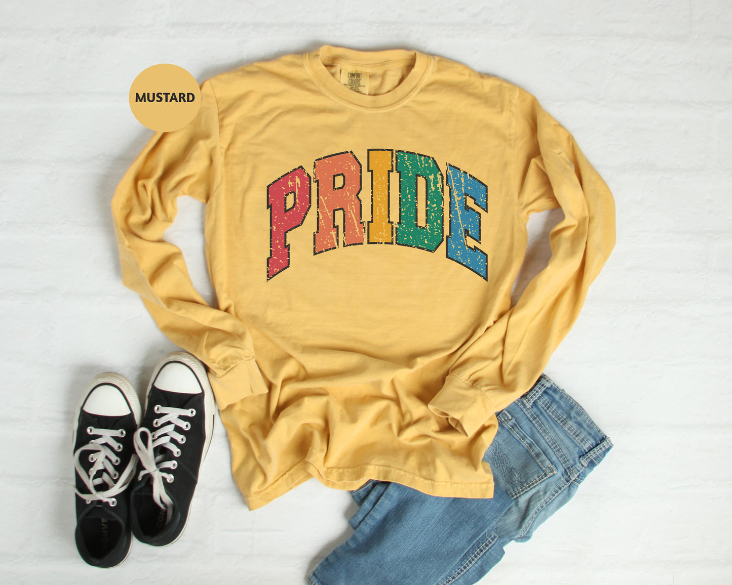 a yellow shirt with the word pride printed on it