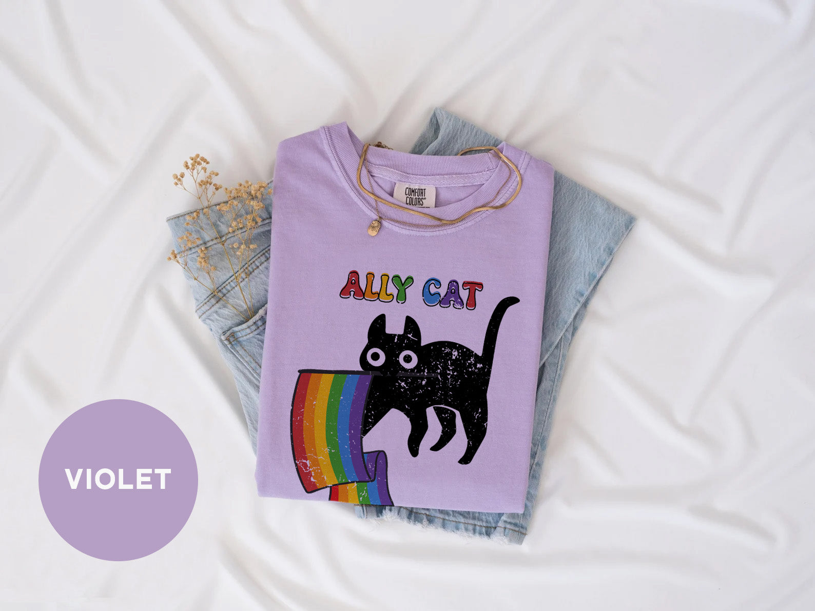 a purple shirt with a black cat on it