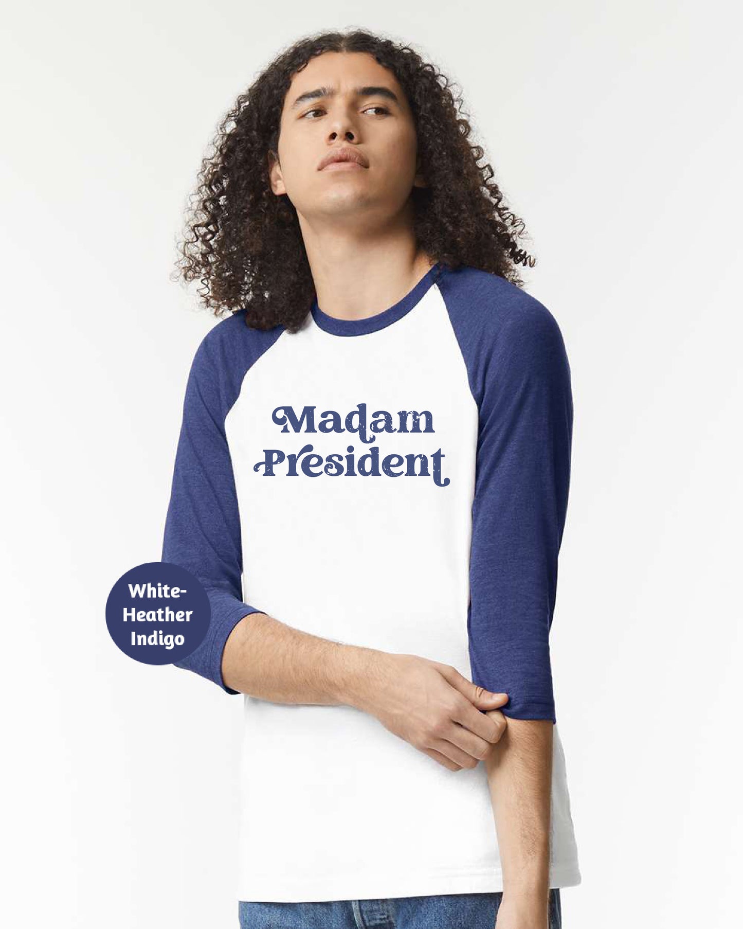 a man with long curly hair wearing a white and blue shirt