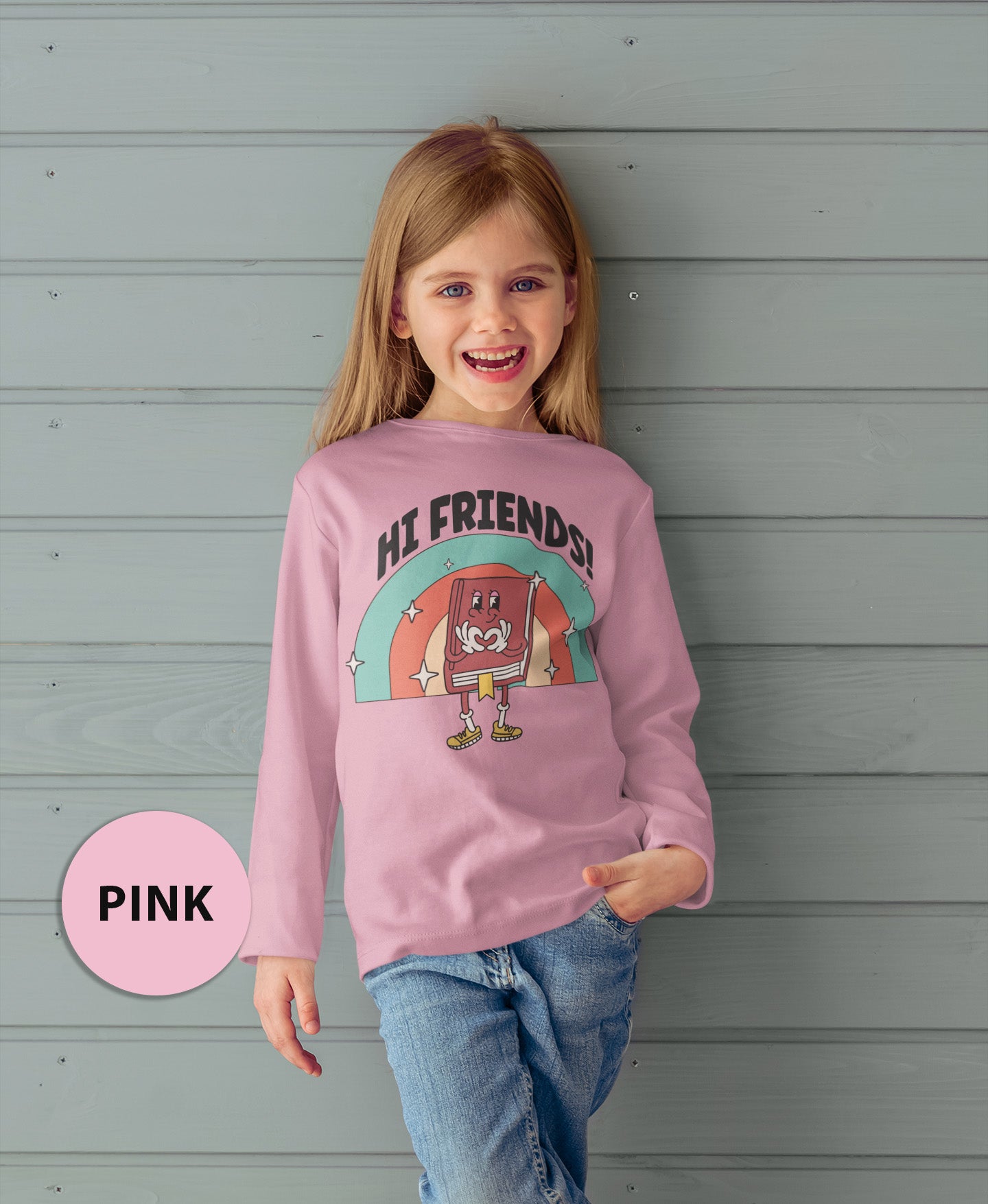 a little girl wearing a pink shirt with a cartoon character on it