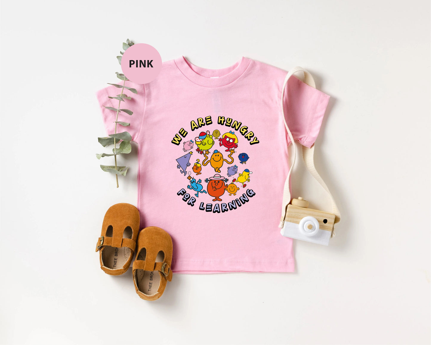 a pink t - shirt with the words pink on it next to a pair of