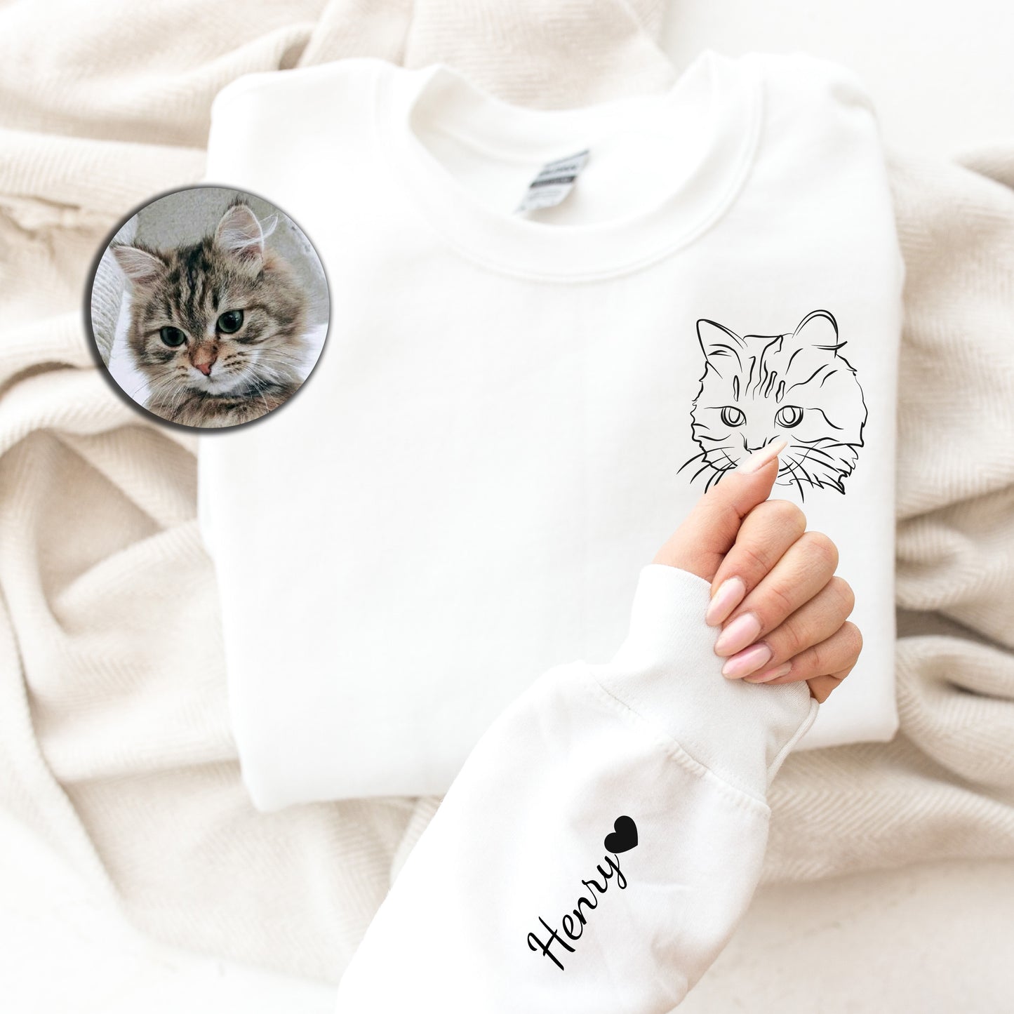 a person holding a white shirt with a picture of a cat on it