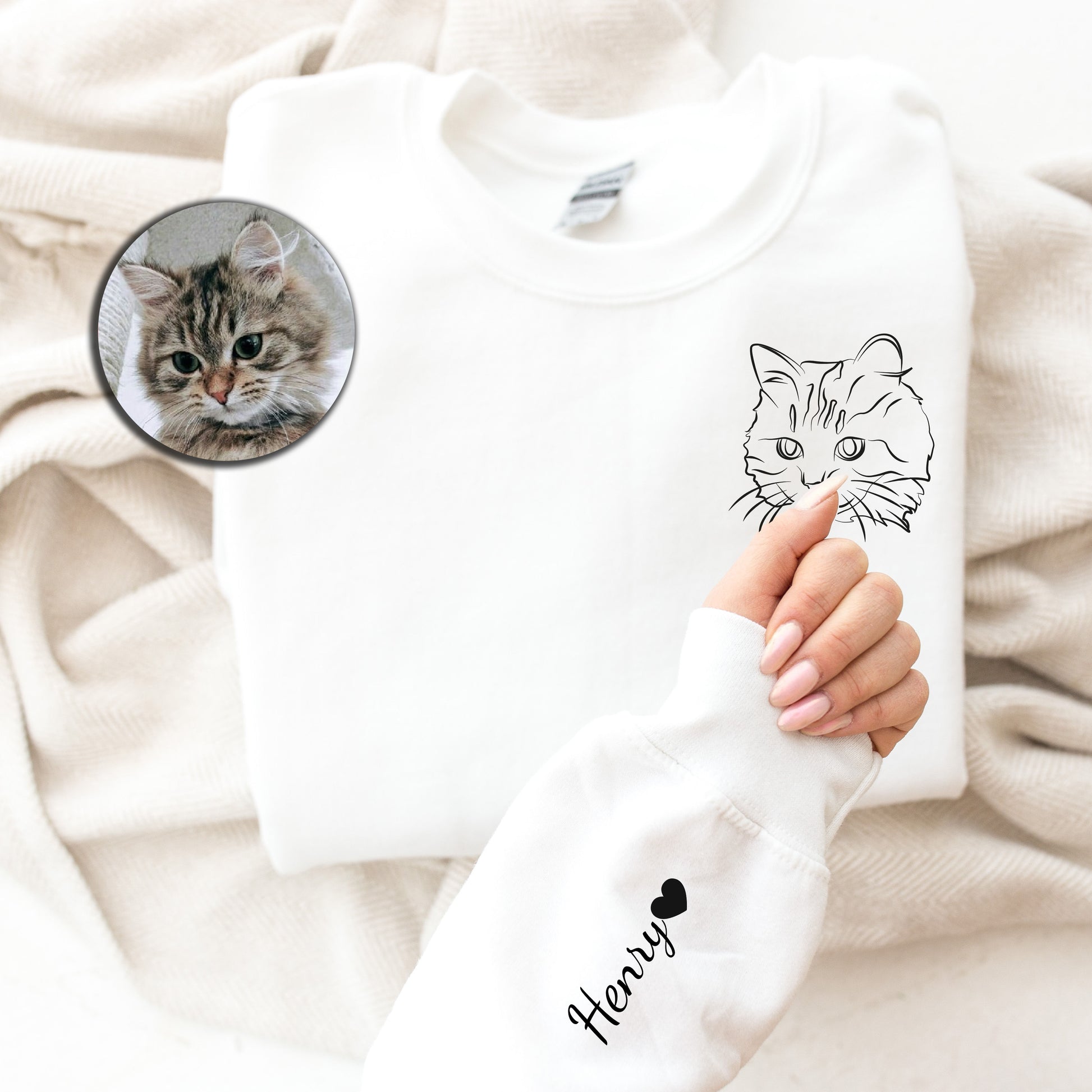 a person holding a white shirt with a picture of a cat on it