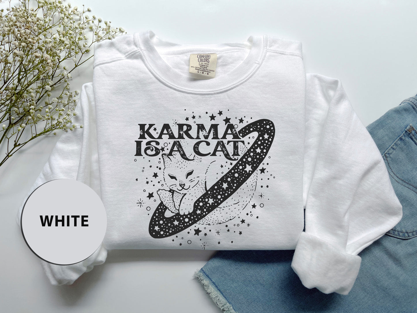 a white t - shirt with the words karma is a cat on it