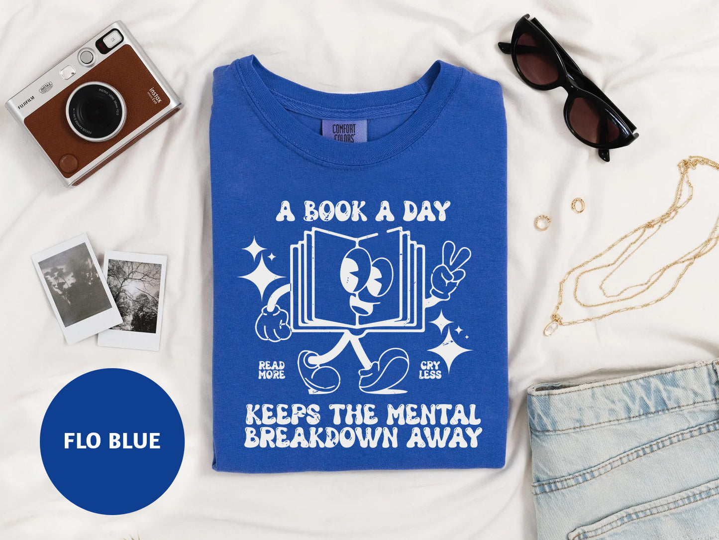a blue shirt with a book a day on it