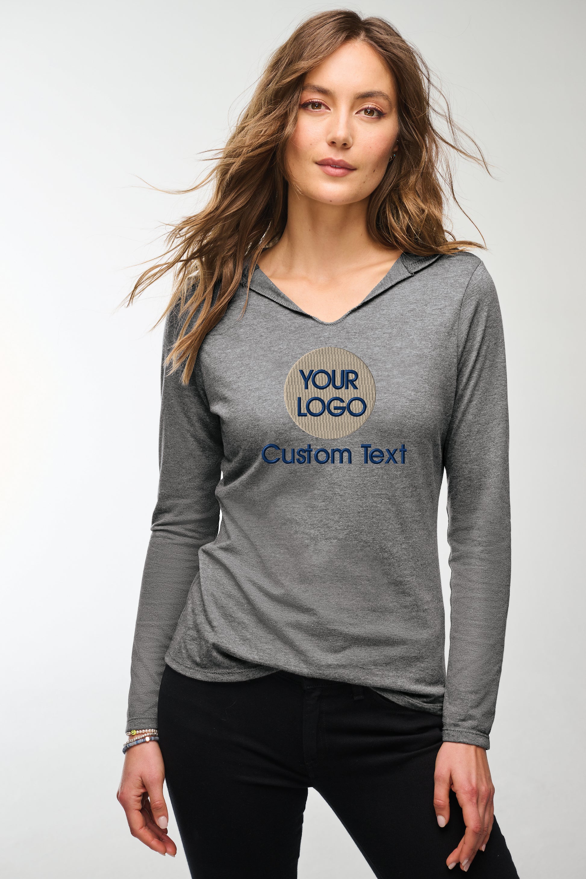 a woman wearing a gray shirt and black pants