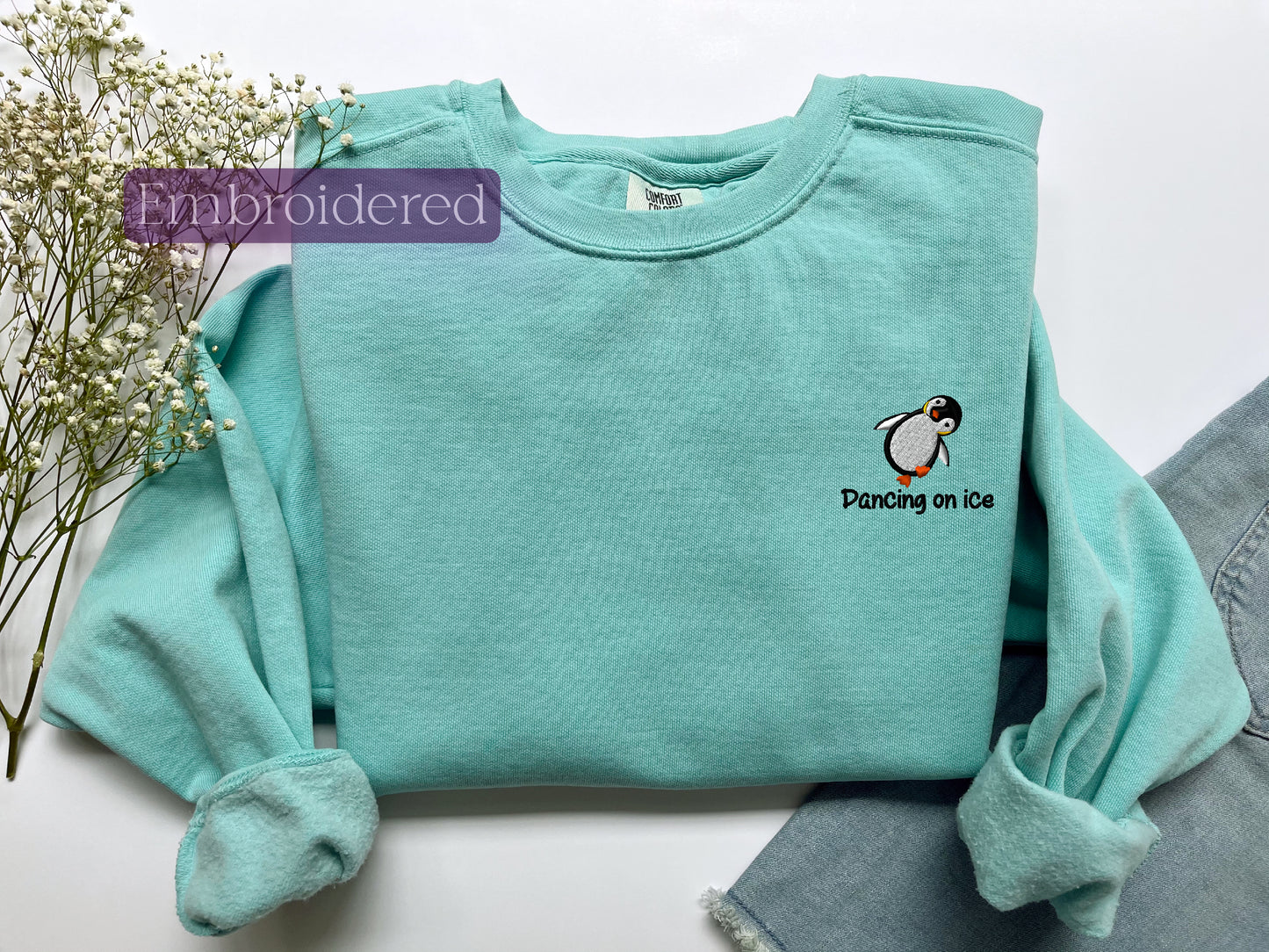 a green shirt with a penguin on it