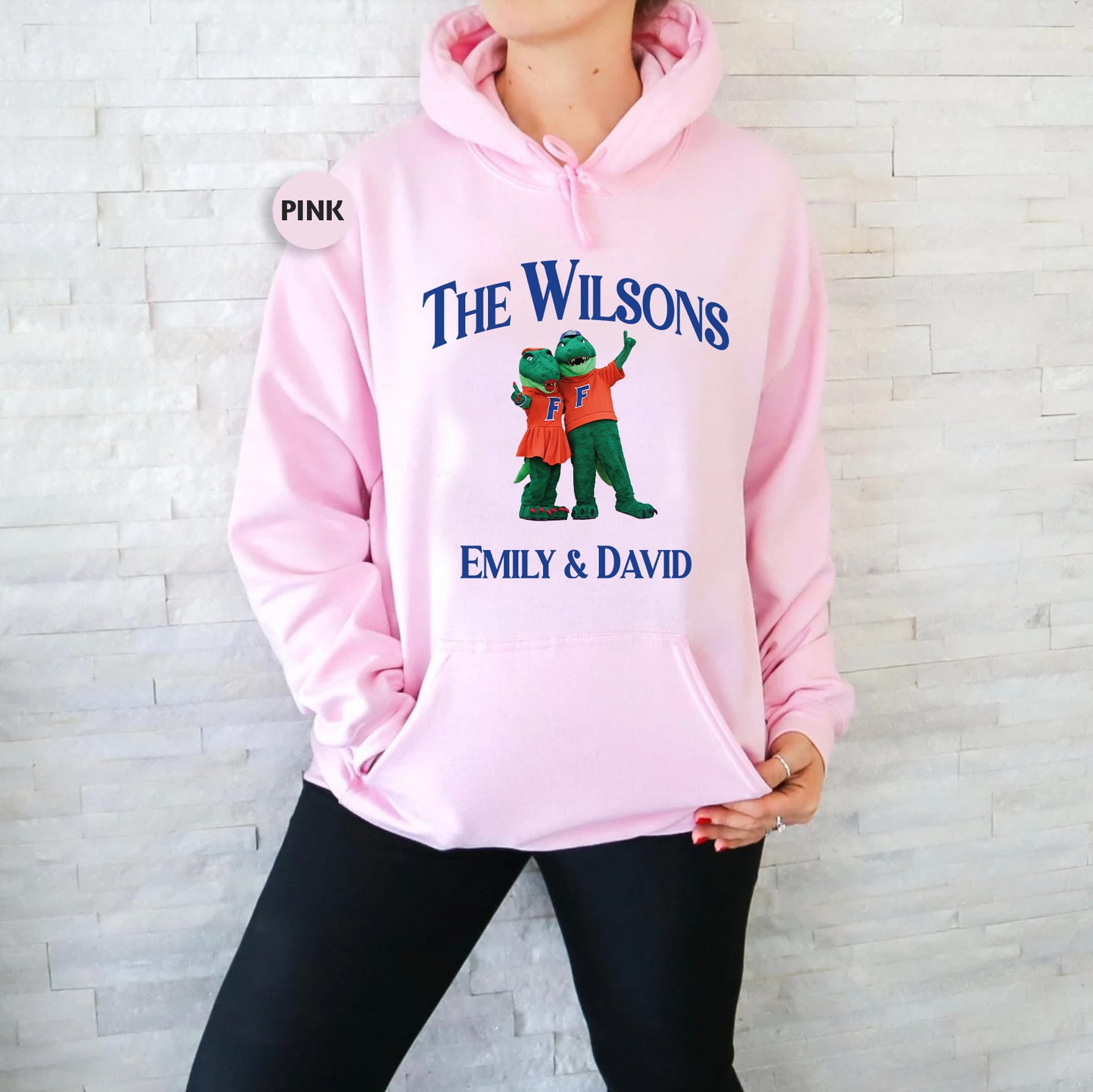 a woman wearing a pink hoodie with the words, the wilson's,