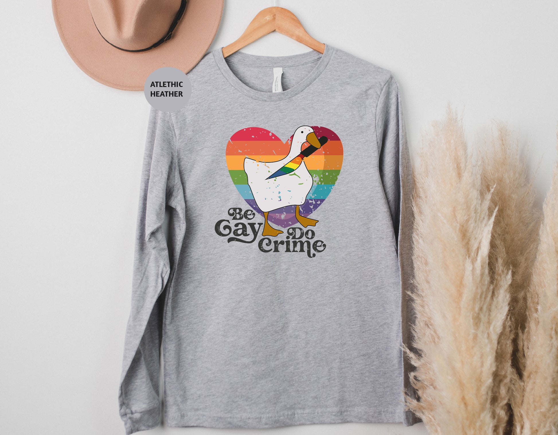 a t - shirt that says be gay do crime next to a hat