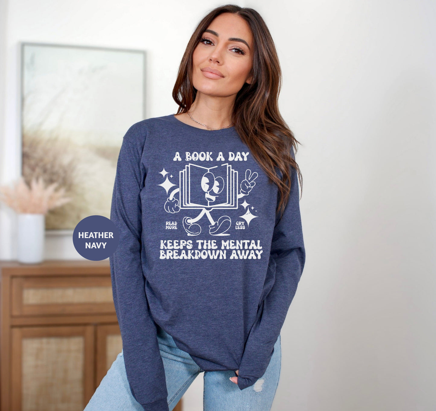 a woman wearing a blue sweatshirt that says a book a day keeps the mental breakdown