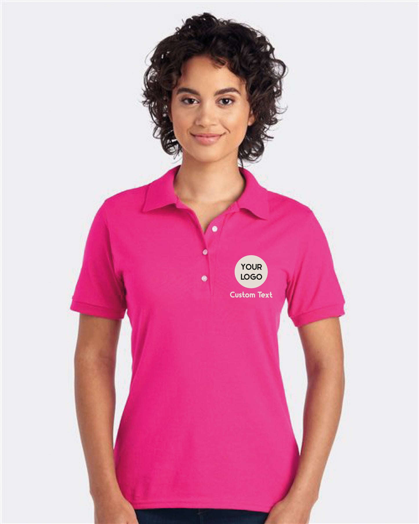 a woman wearing a pink polo shirt with a logo on it