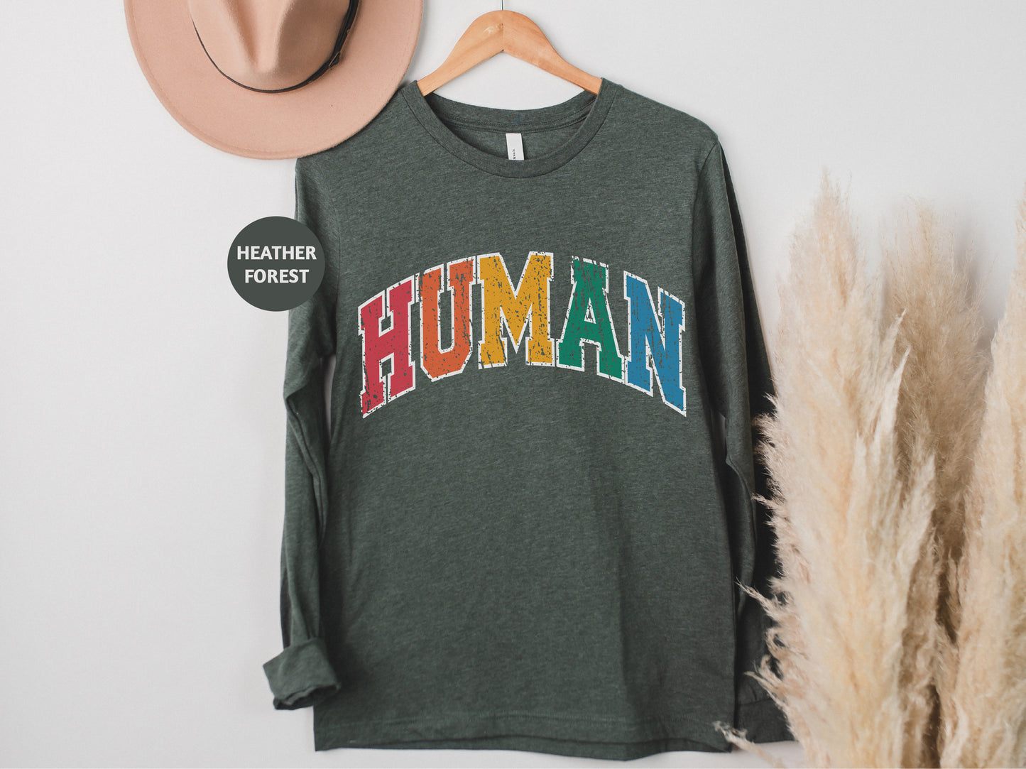 a green shirt with the word human printed on it