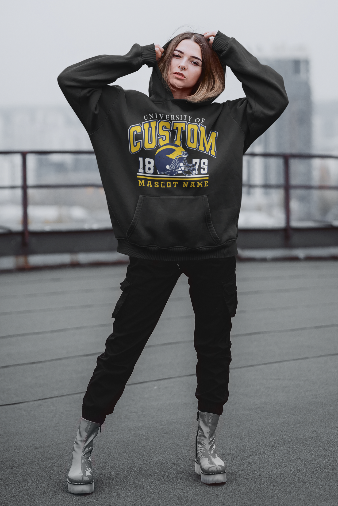 a woman in a black hoodie posing for a picture