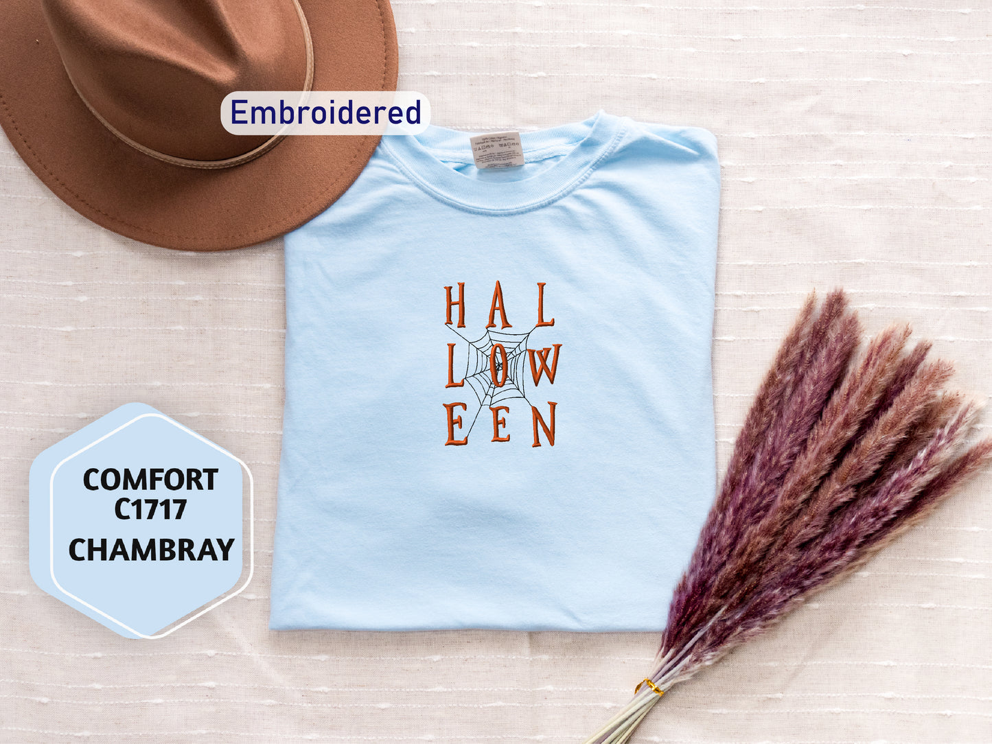 a hat, t - shirt, and a dried plant on a table