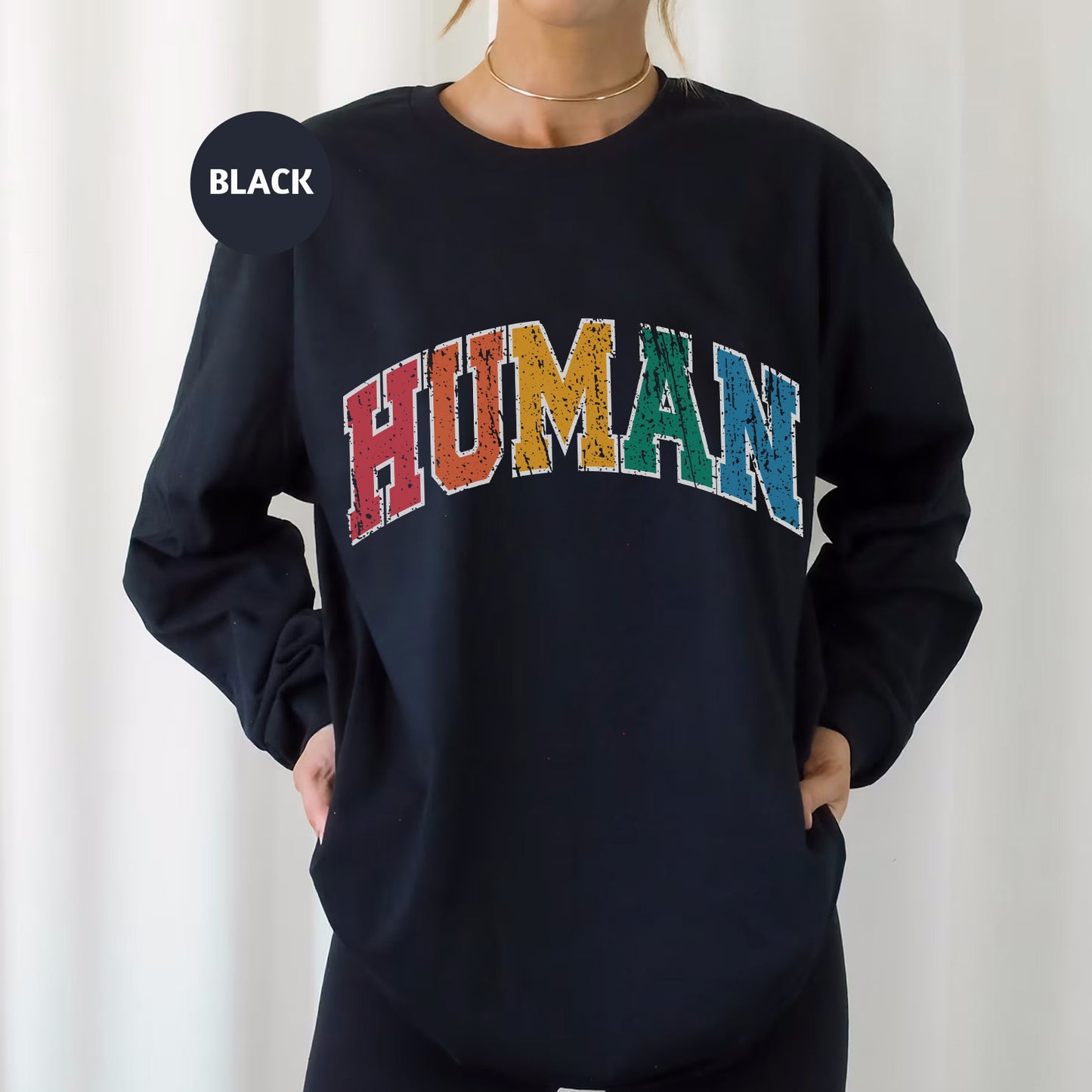 a woman wearing a black sweatshirt with the word human printed on it