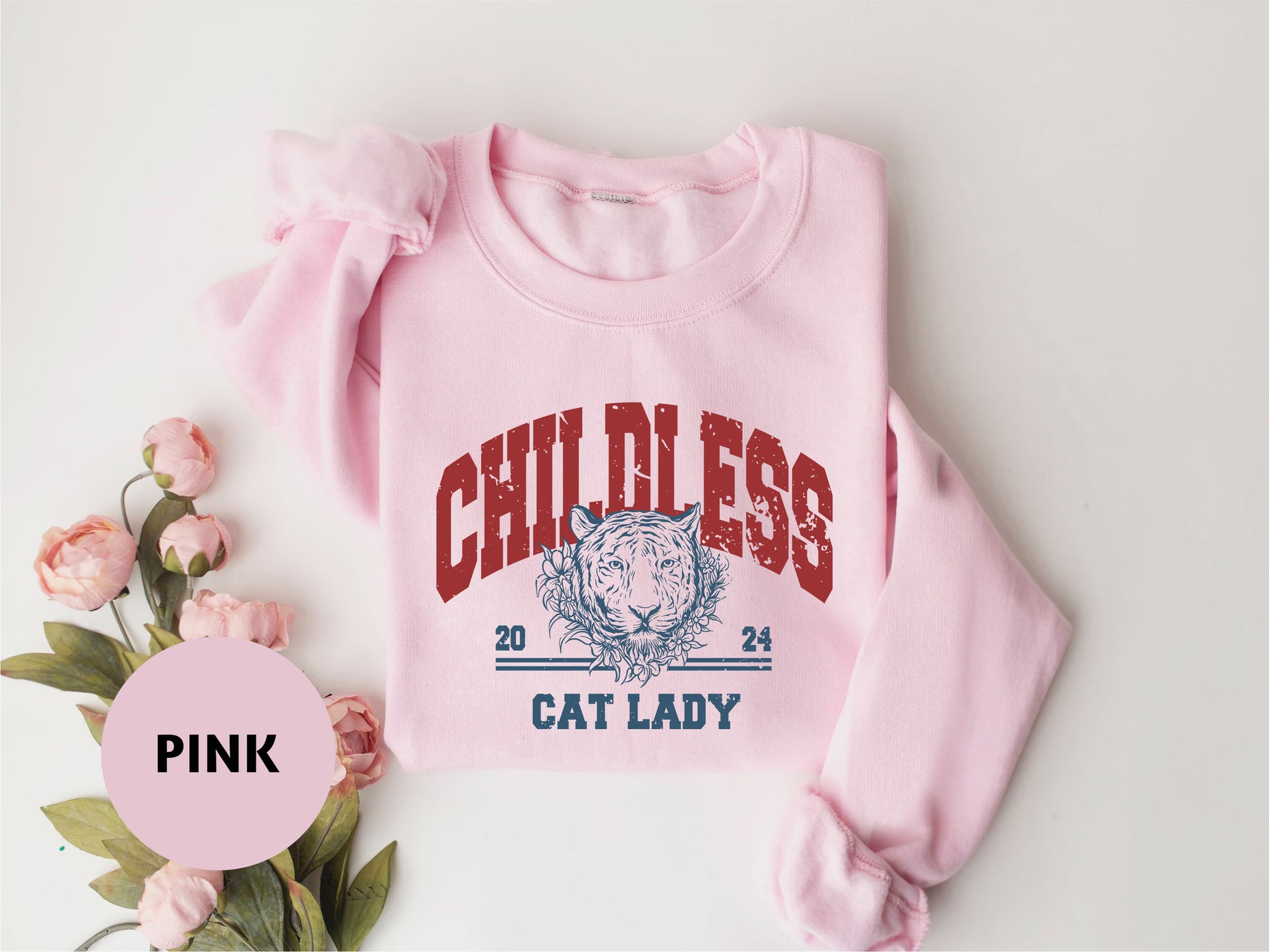 a pink sweatshirt with a picture of a cat on it