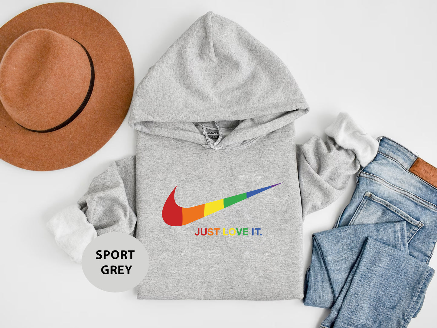 a hoodie, jeans, hat, and a pair of shoes on a white