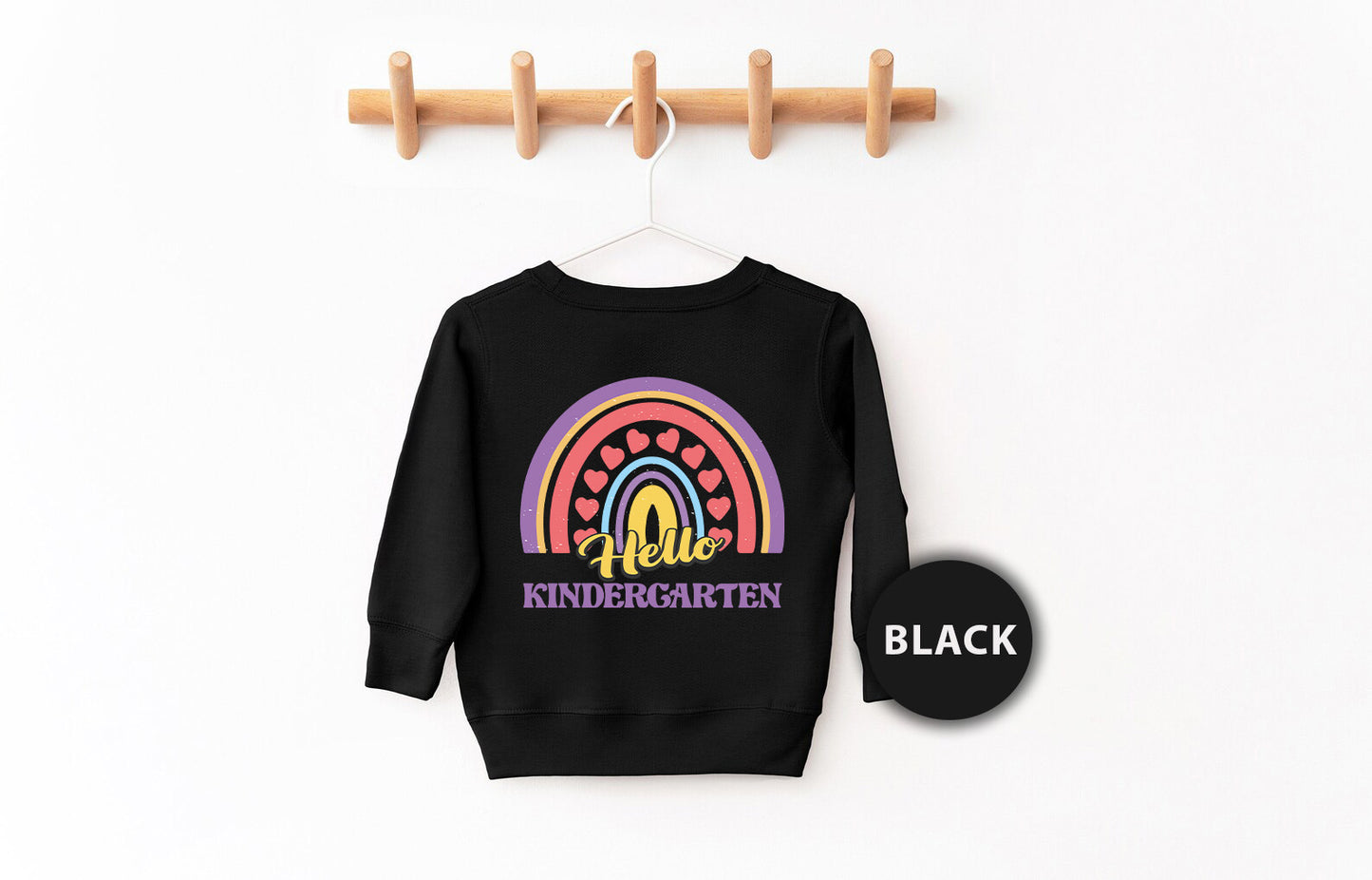a black sweatshirt hanging on a clothes rack
