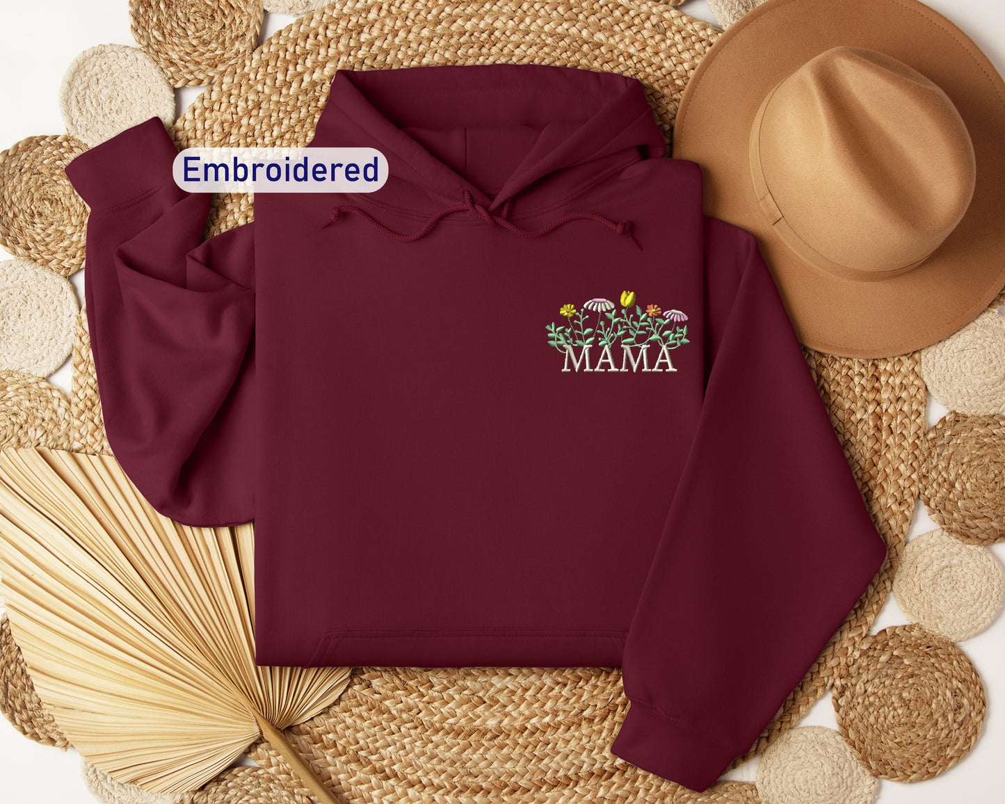 a maroon hoodie with the words embroidered on it