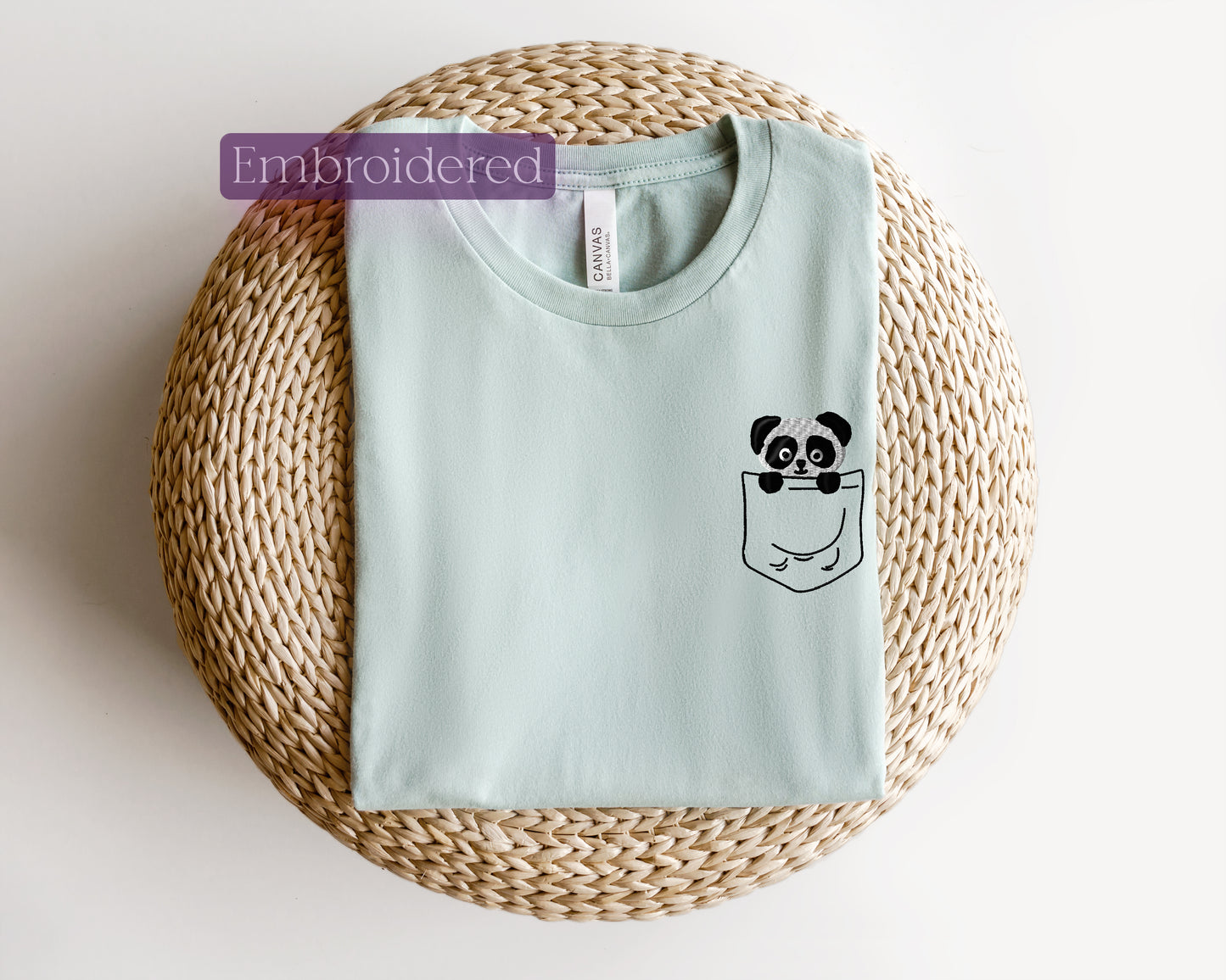 a t - shirt with a panda in a pocket on it