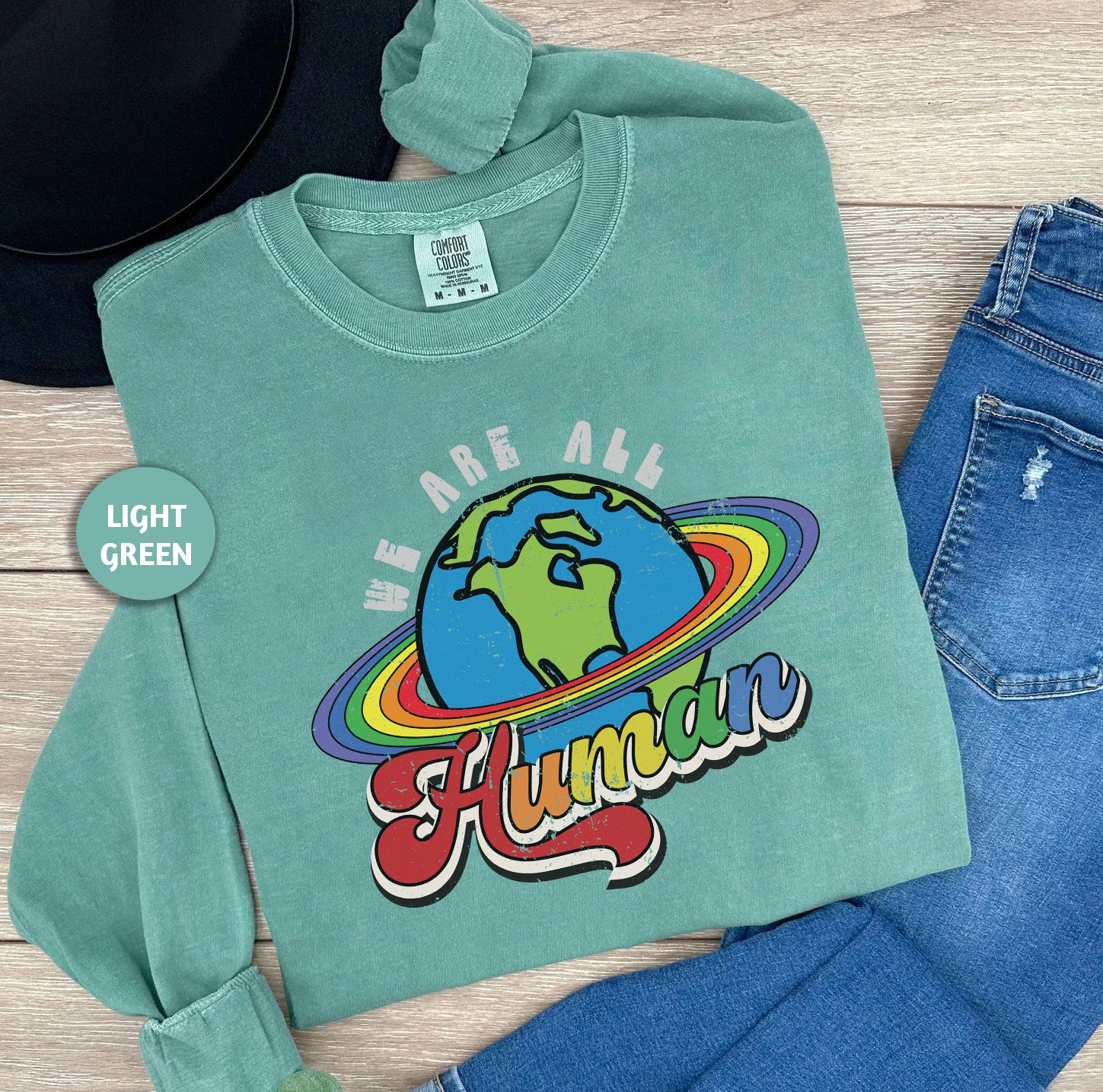 a green shirt that says we are 4h and has a picture of the earth