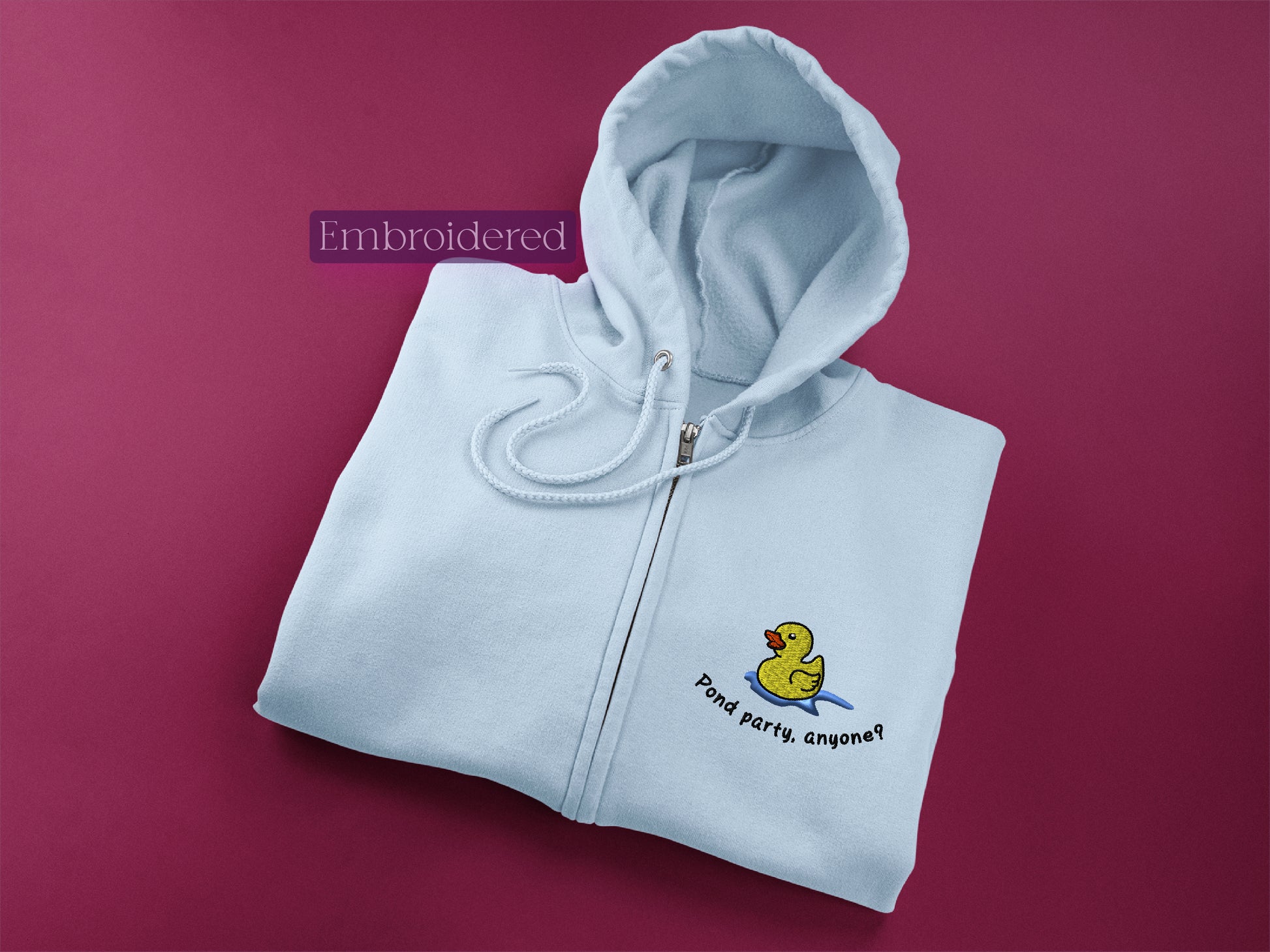 a white hoodie with a rubber duck on it