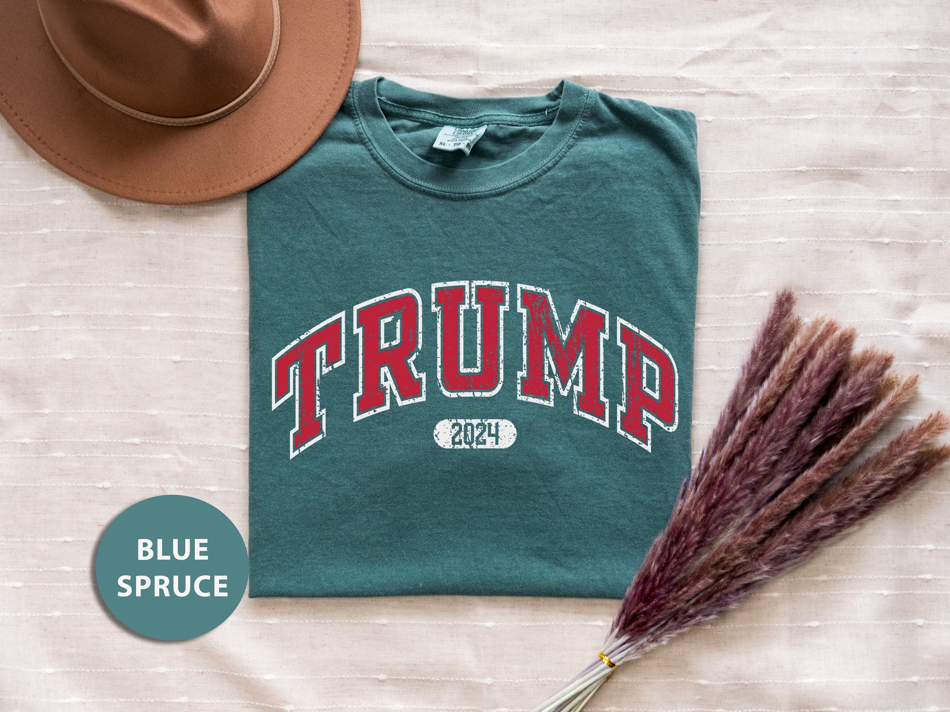a t - shirt with the word trump on it next to a straw hat and