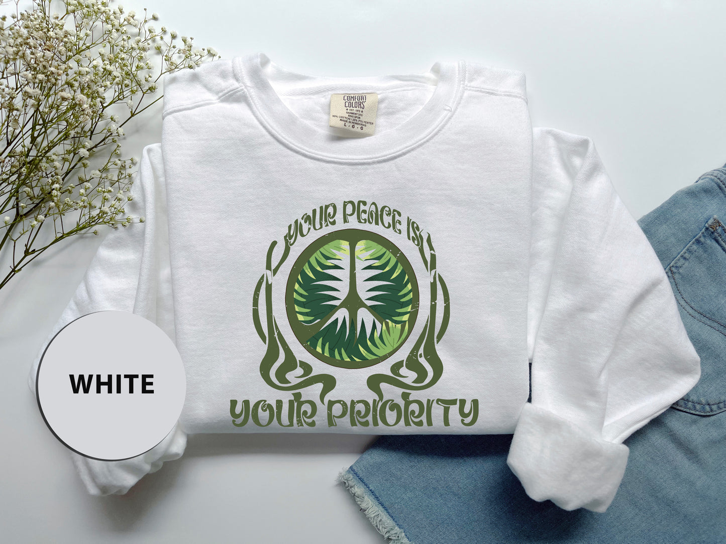 a white shirt with a green tree on it