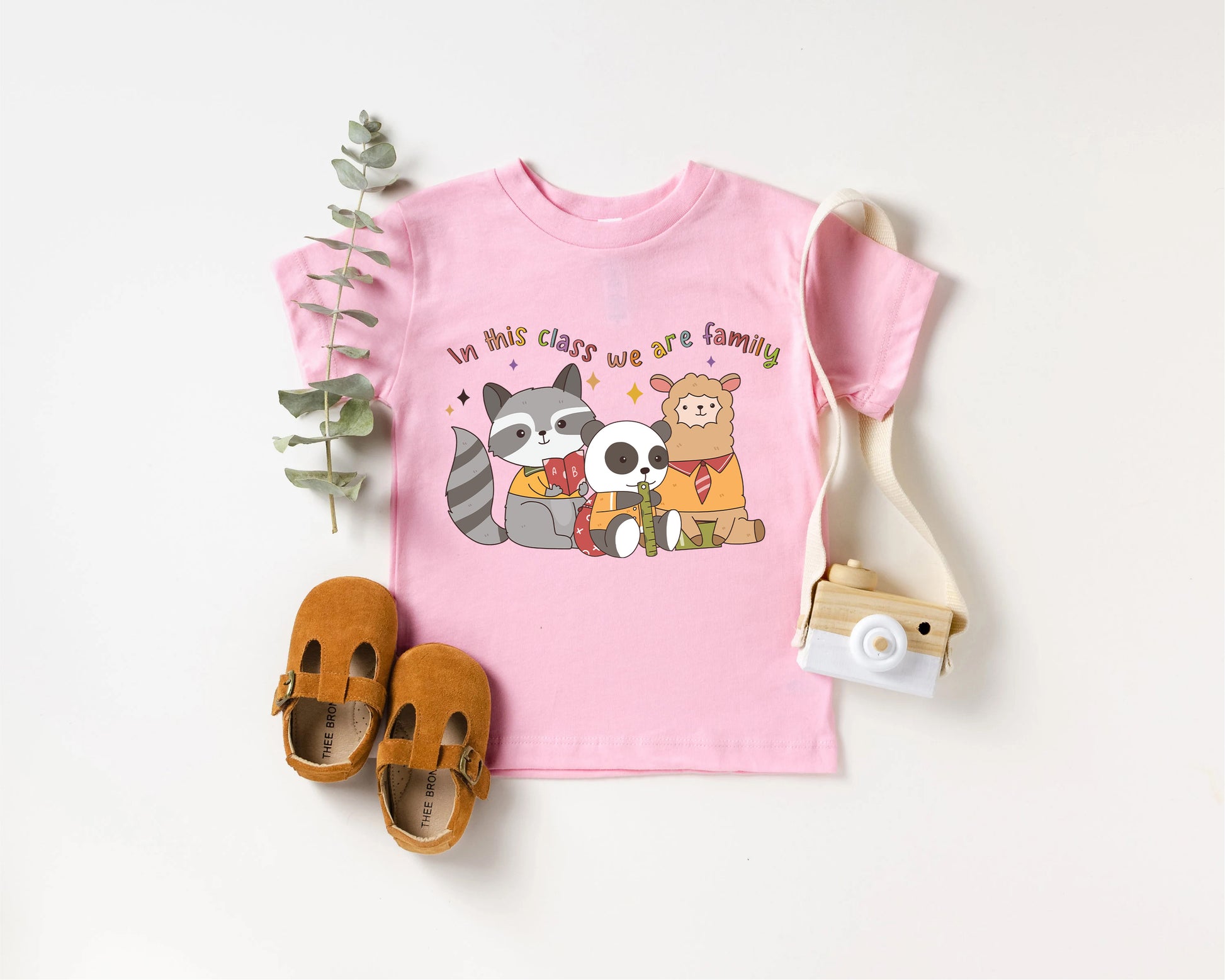 a pink shirt with a raccoon and panda on it