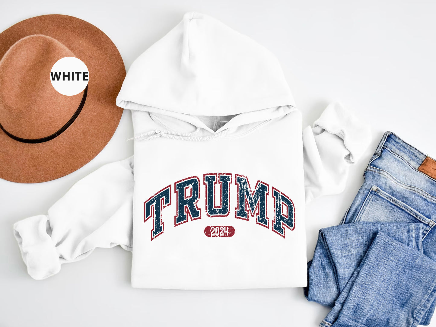 a white hoodie, jeans, hat, and a pair of jeans