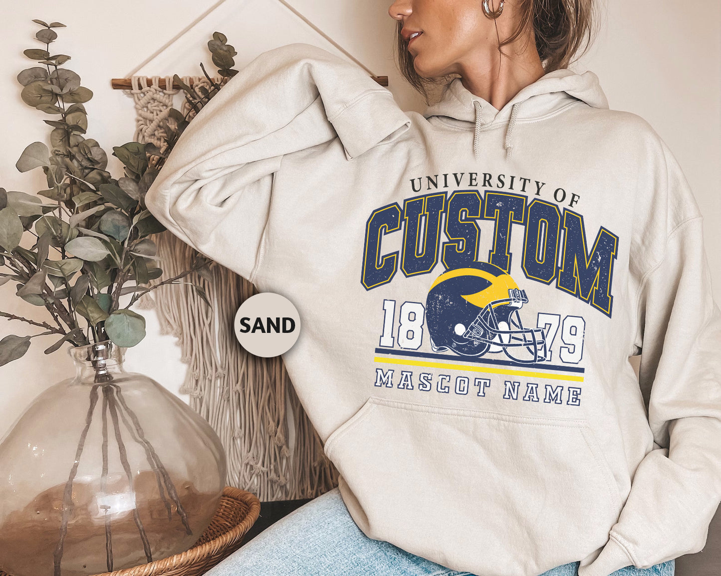 a woman wearing a sweatshirt with a football helmet on it