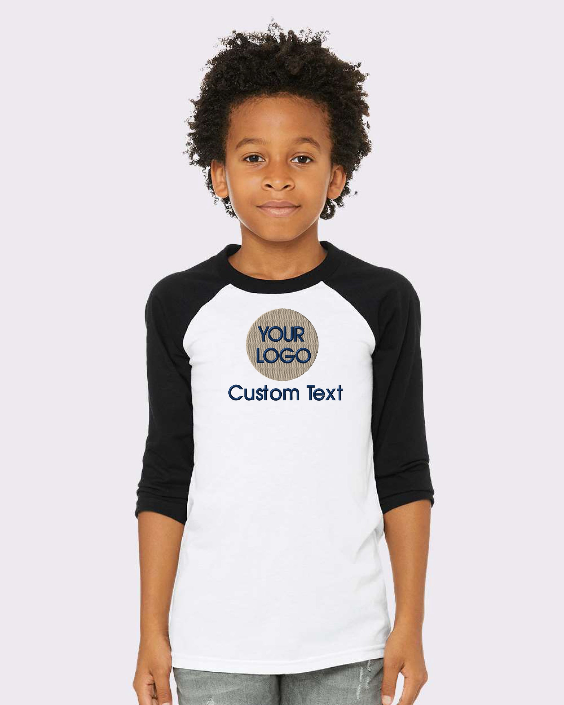 a young boy wearing a white and black shirt