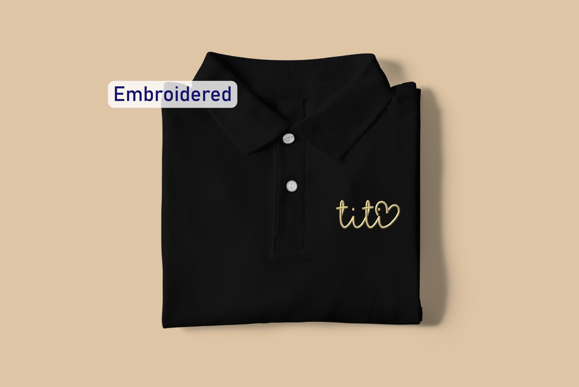 a black polo shirt with the words embroidered on it