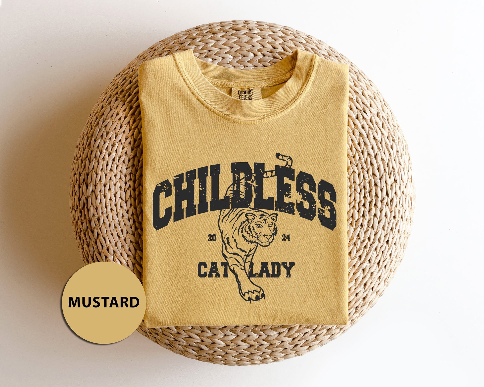 a child's t - shirt sitting on top of a wicker basket