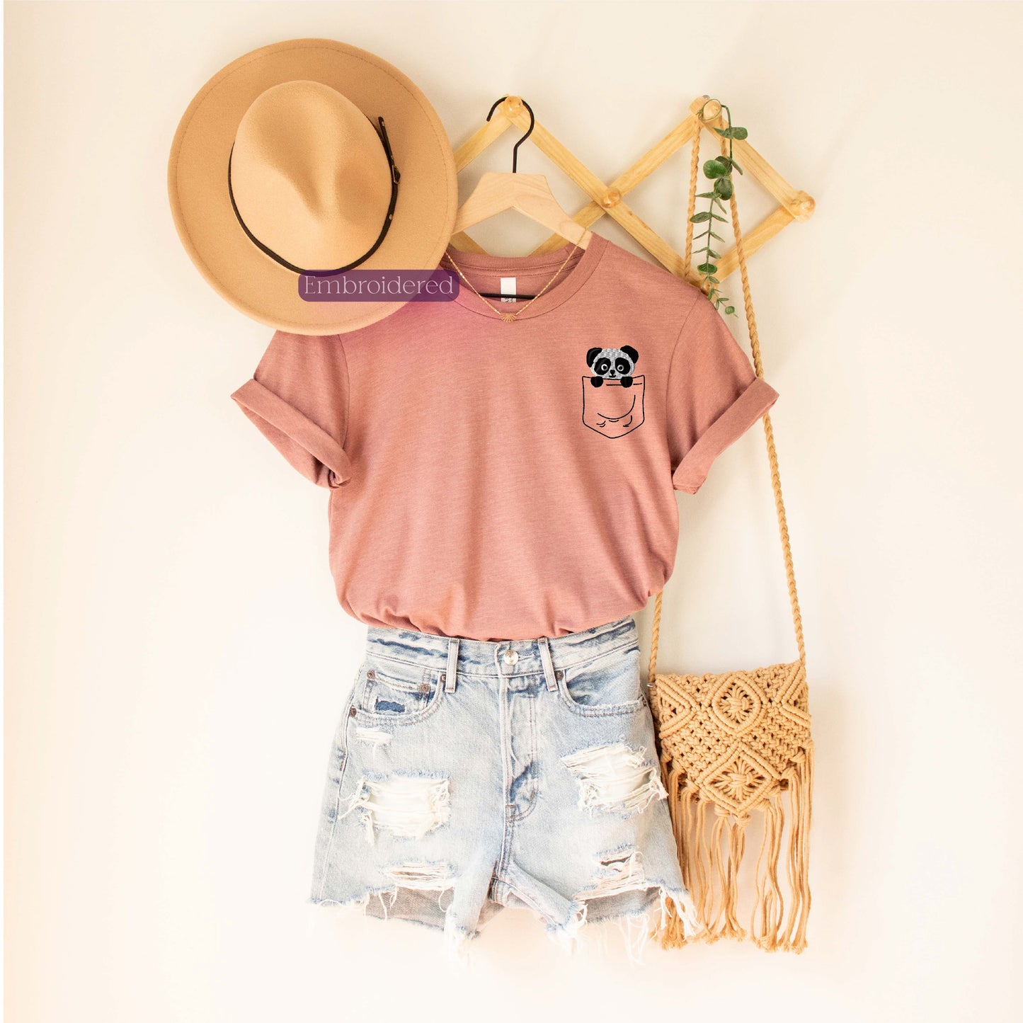 a hat, a t - shirt, and a straw bag are hanging on a