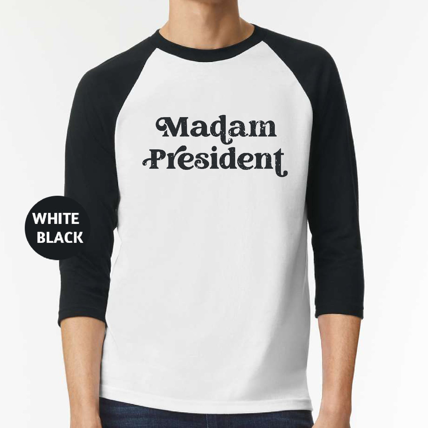 a man wearing a black and white shirt with the words madam president on it
