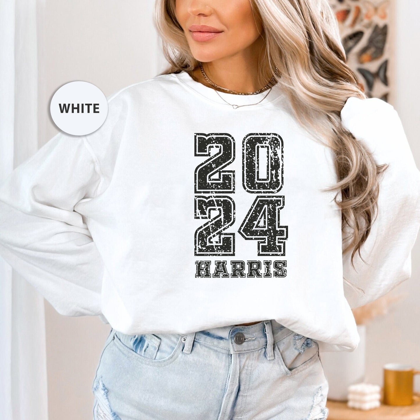 a woman wearing a white sweatshirt with the number twenty four printed on it