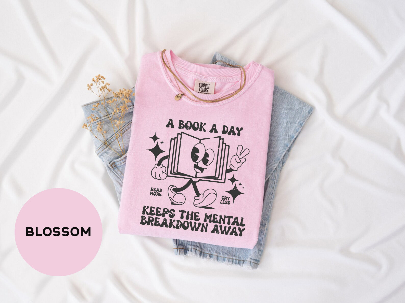 a pink shirt that says, a book a day keeps the mental breakdown away