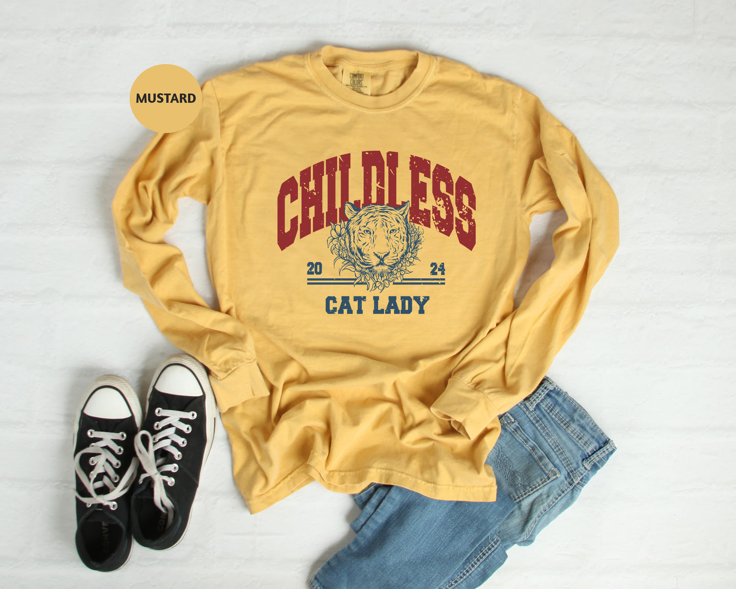 a yellow shirt that says cat lady next to a pair of black shoes