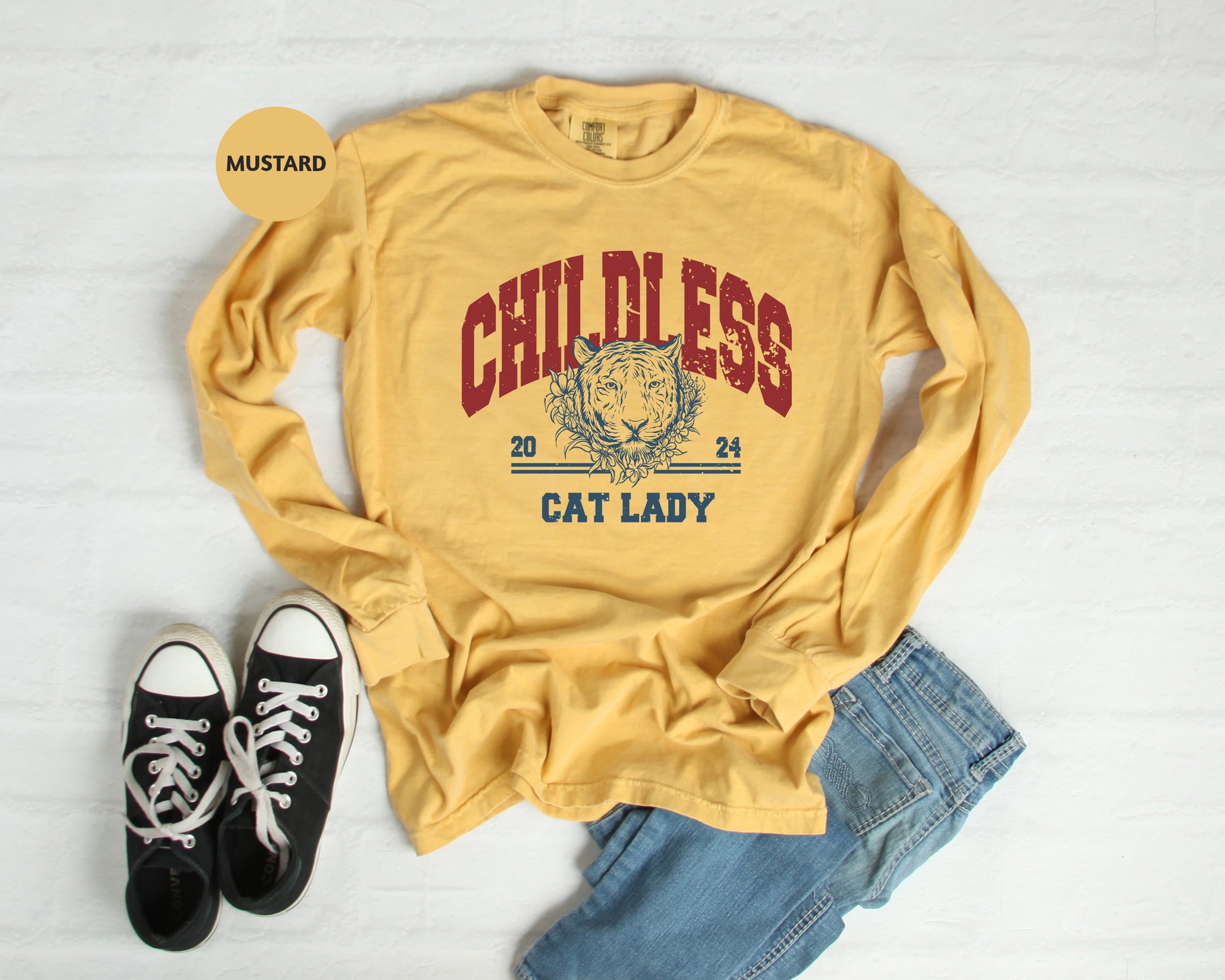 a yellow shirt that says cat lady next to a pair of black shoes