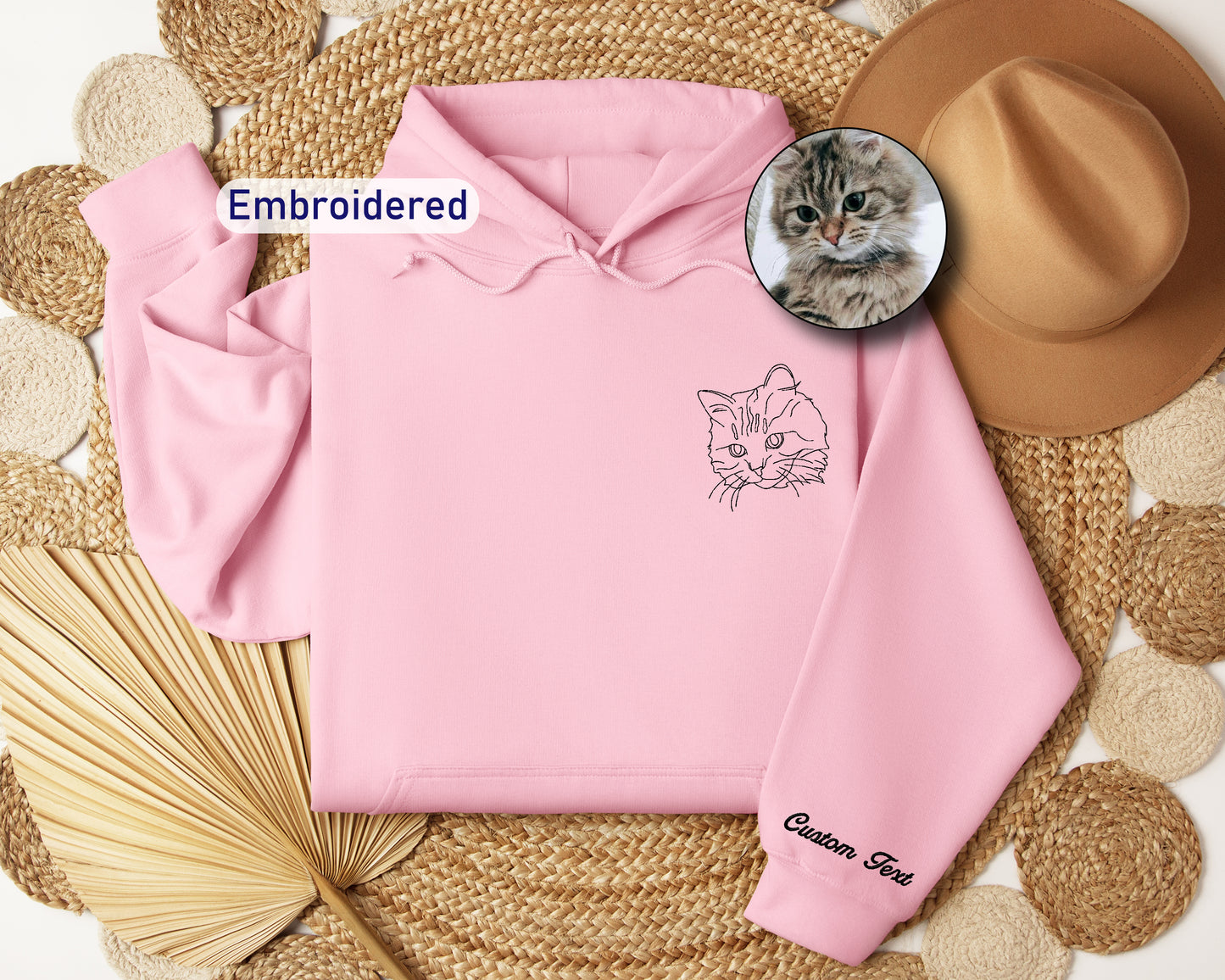 a pink hoodie with a picture of a cat on it