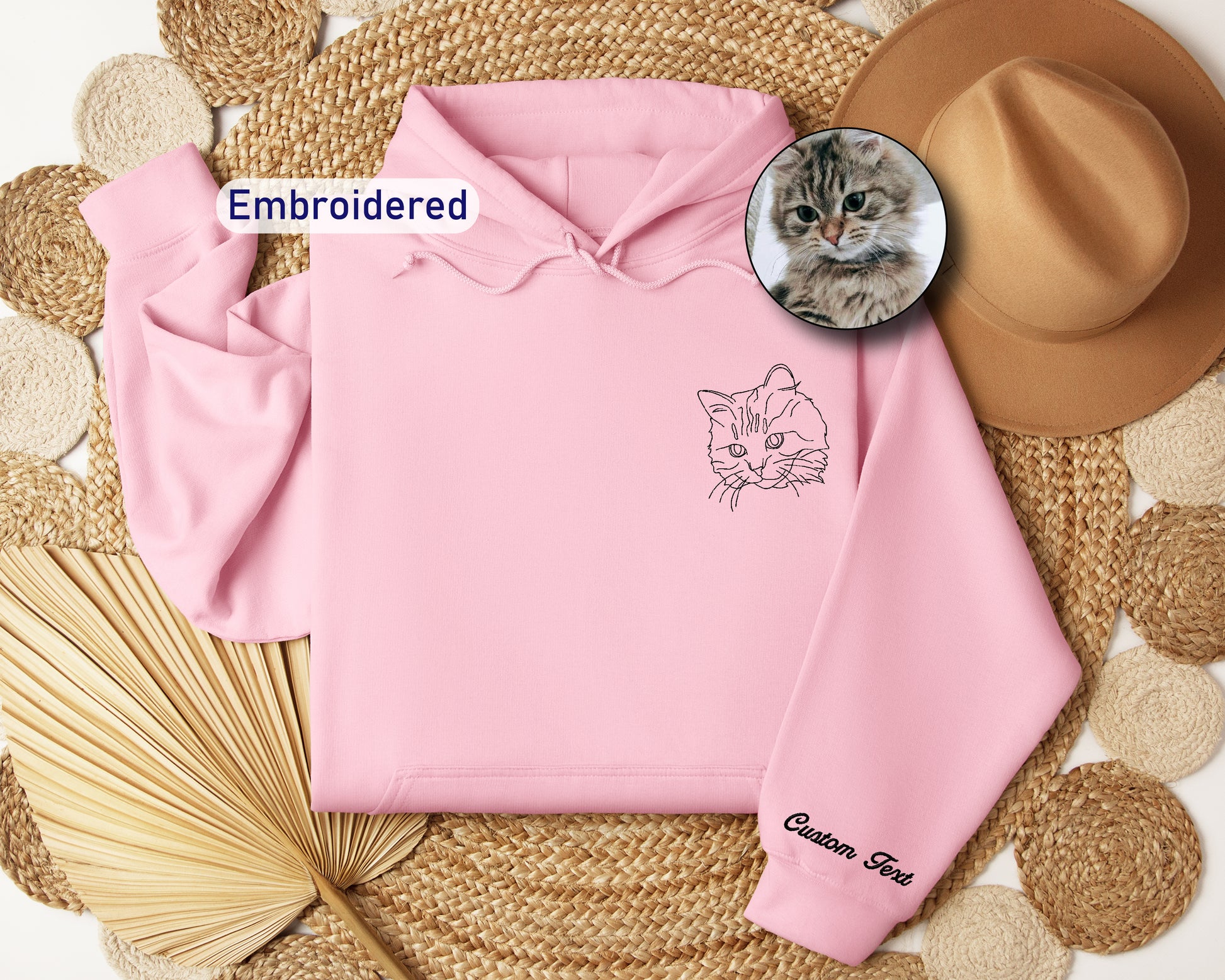a pink hoodie with a picture of a cat on it