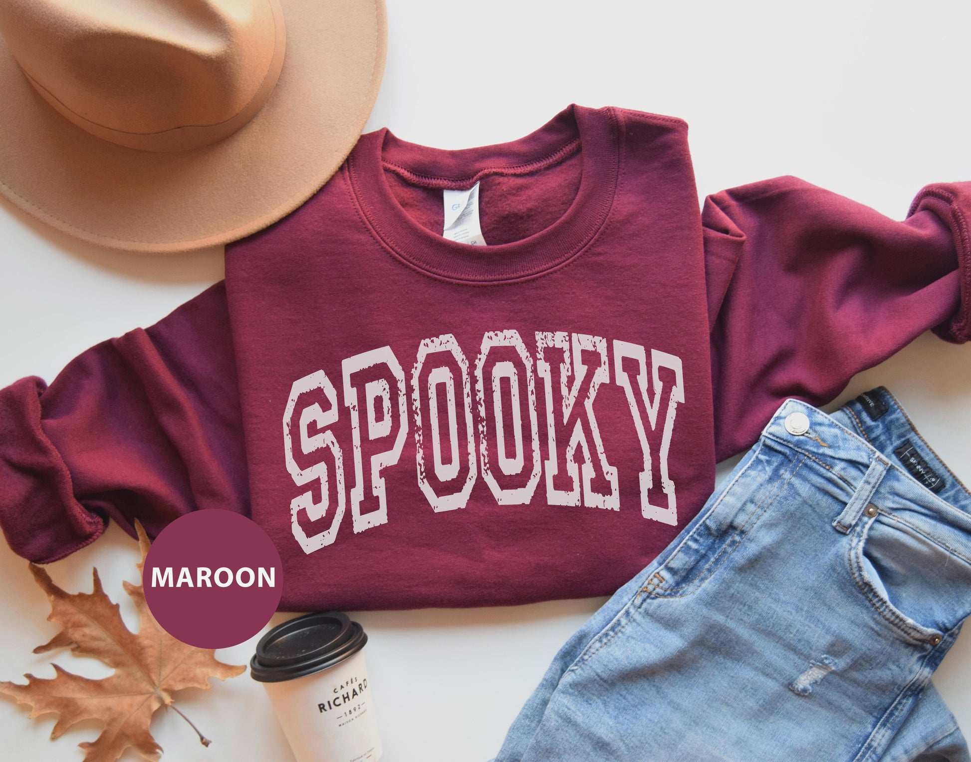 a maroon shirt with the word spooky on it
