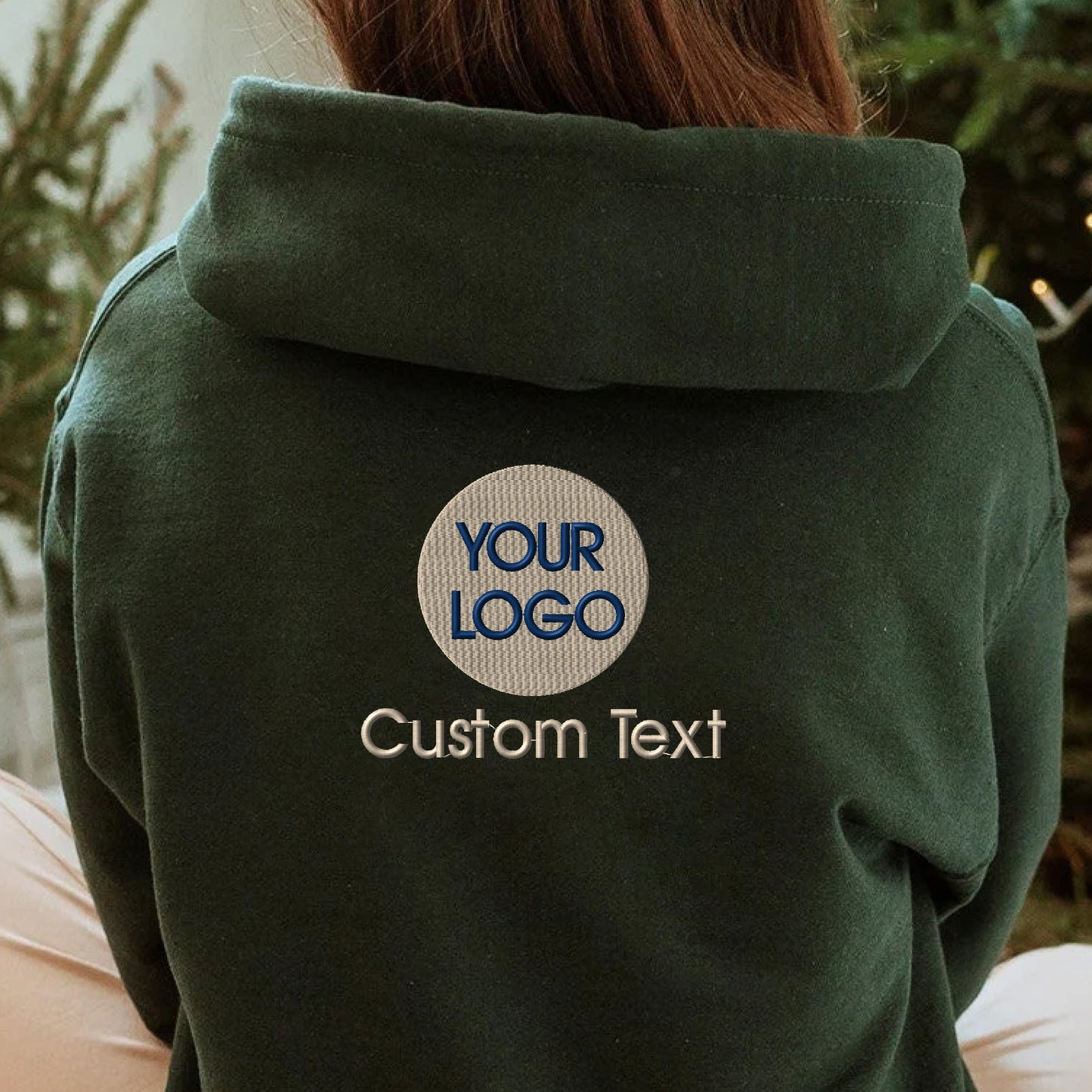 a woman wearing a green hoodie with a logo on it